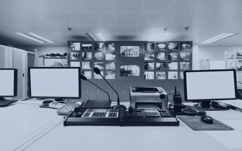 Monitoring workstations and a video wall in an operations room.